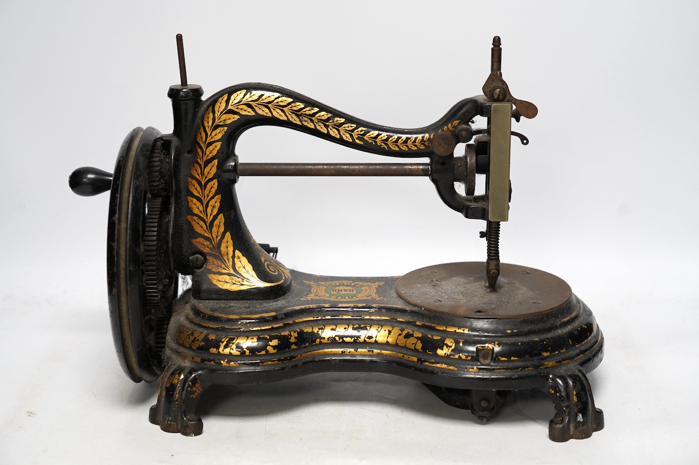 A late 19th century Jones swan neck sewing machine, with cast iron base and gilt decorated frame. Condition - fair